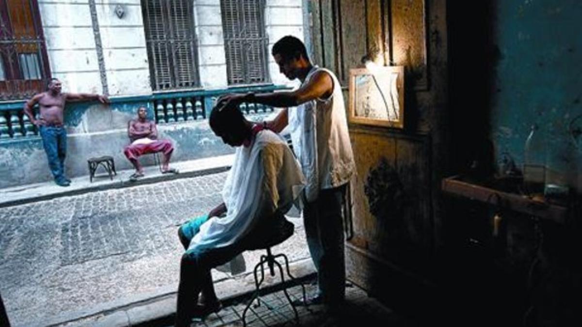 A media luz 8 El barbero Miguel González atiende a un cliente en La Habana, en una imagen de archivo.