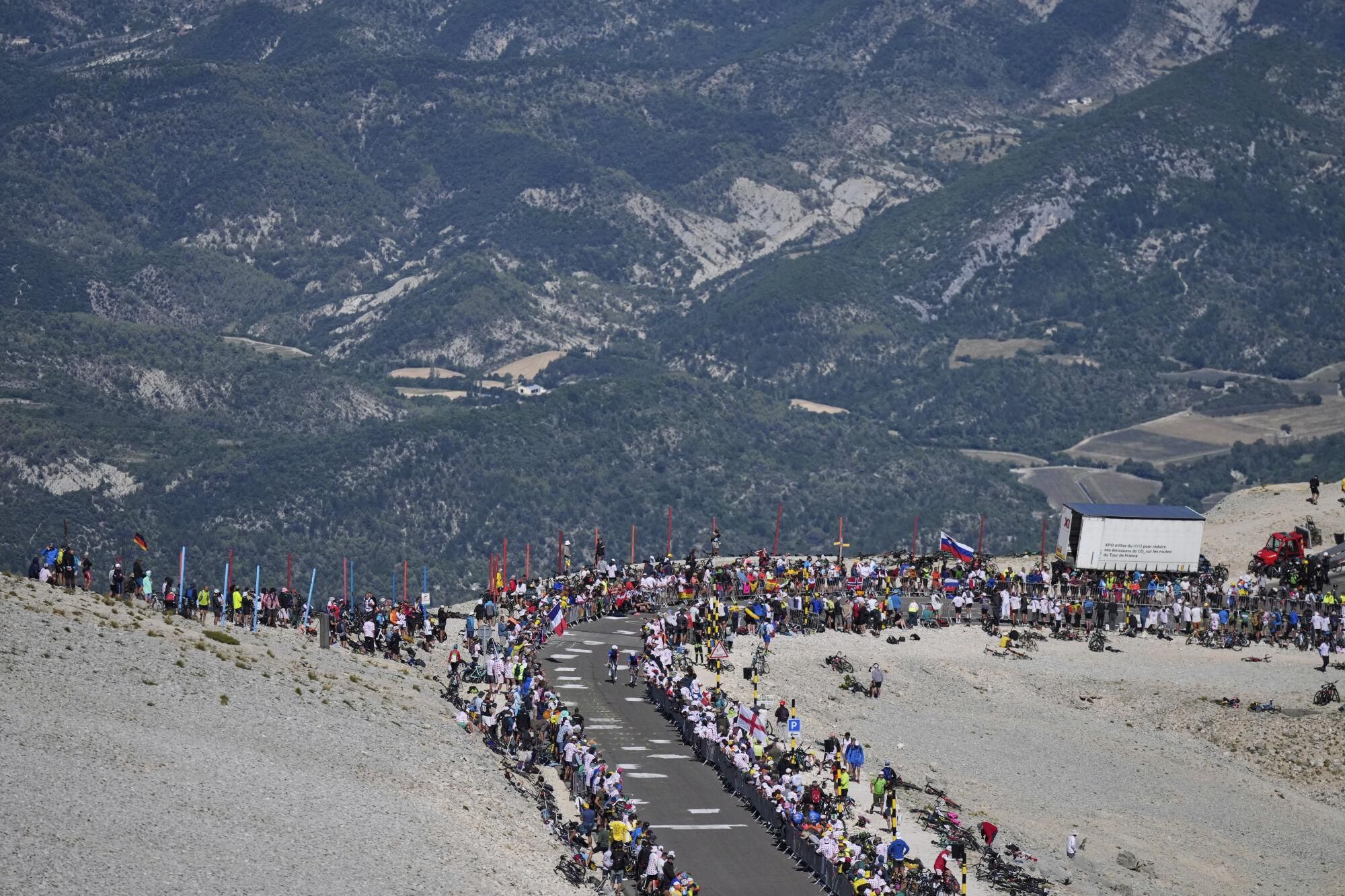 Riders climb in the Lunar landscape of the Mont Ventoux during the sixteenth stage of the Tour de France cycling race over 171.5 kilometers (106.6 miles) with start in Montpellier and finish on the Mont Ventoux, France, Tuesday, July 22, 2025. (AP Photo/Mosa'ab Elshamy)