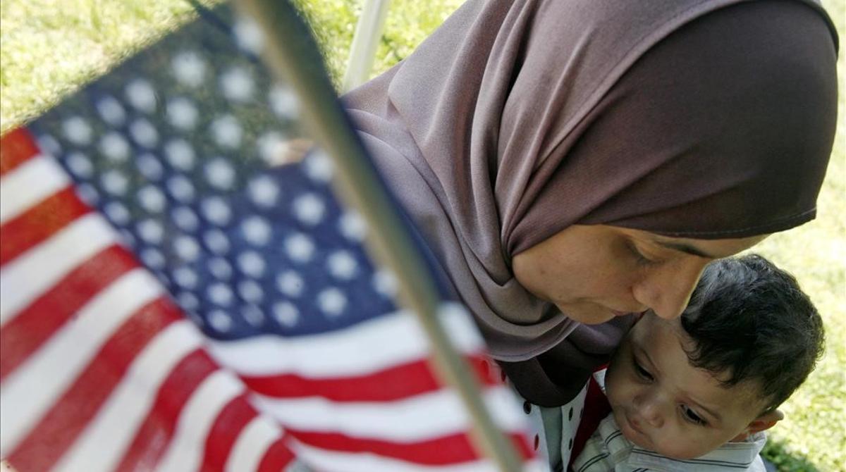 Karima Mezry of Morocco hugs her son Soufiane after taking the oath of citizenship to become an American citizen during a U S  Citizenship and Immigration Services ceremony in Mount Vernon  Virginia  May 21  2007      REUTERS Jim Young  (UNITED STATES)