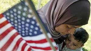 Karima Mezry of Morocco hugs her son Soufiane after taking the oath of citizenship to become an American citizen during a U S  Citizenship and Immigration Services ceremony in Mount Vernon  Virginia  May 21  2007      REUTERS Jim Young  (UNITED STATES)
