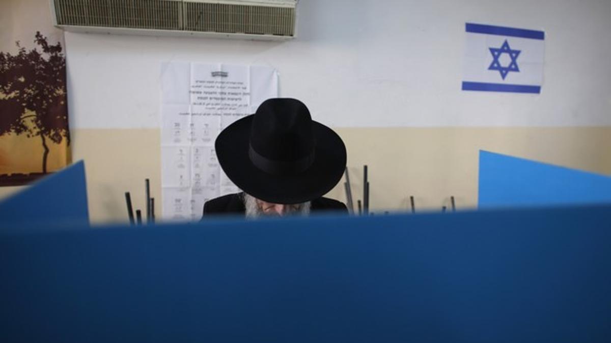 Un judío ultraortodoxo deposita su voto, este martes, en un colegio electoral en Jerusalén.