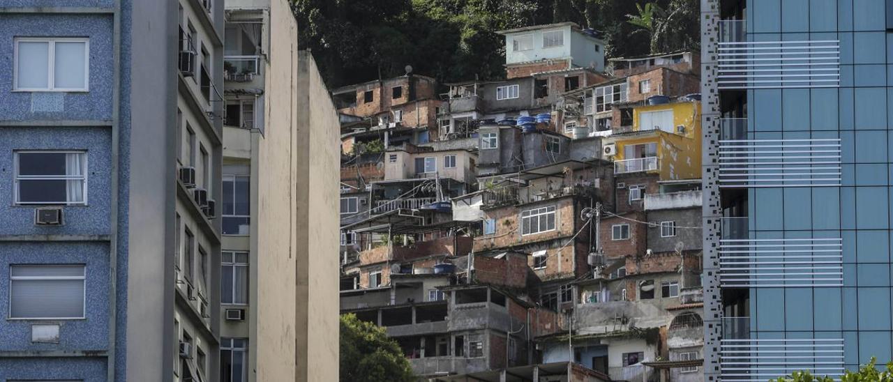 En la playa de Copacabana, en Brasil, la vista de los edificios de lujo choca con la imagen de las favelas que se vislumbran en el fondo.