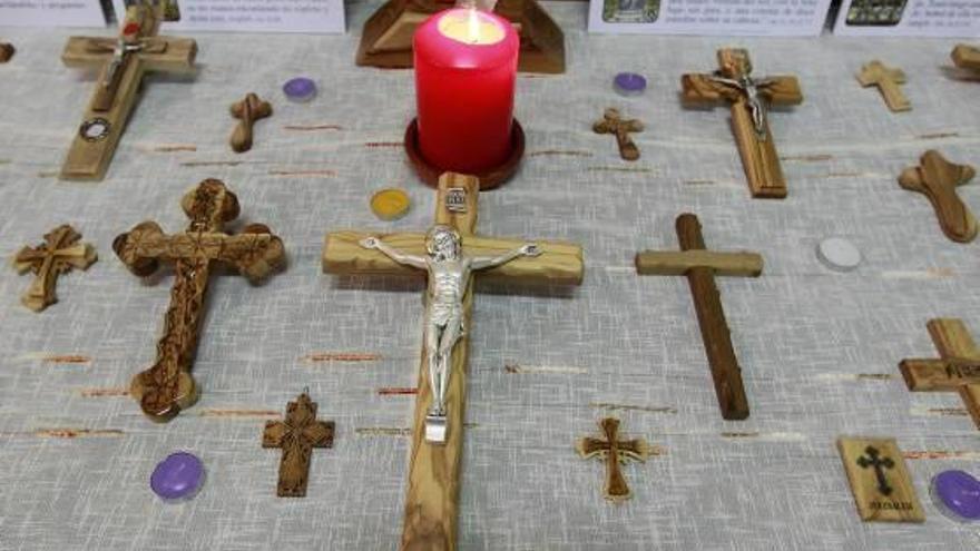 cruces de todo el mundo. Crucifijos de todos los materiales se agrupan en las mesas de la sede de la hermandad del Santísimo Cristo de los Afligidos junto a diversas oraciones.La mayoría de las representaciones muestran a Jesús todavía vivo en la cruz, con los ojos abiertos, imagen que define a la fraternidad del Canyamelar.La «Cruz del Hambre» es la gran novedad en esta edición de la muestra. Los visitantes aportan comida para los más necesitados.y Formas icónicas cuelgan de las paredes del recinto. En la muestra hay crucifijos llegados de todo el mundo, incluida tierra santa.Existe una gran variedad en los tamaños de los crucifijos.Una decena de cruces están unidas por cadenas, evitando las perforaciones en las paredes. f josé aleixandre