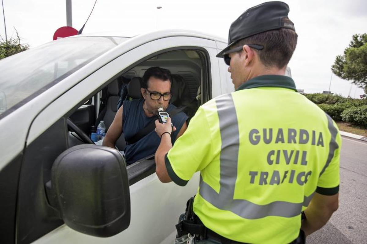 Un agente de la Agrupación de Tráfico de la Guardia Civil realiza un control de alcoholemia en una carretrera de Valencia.
