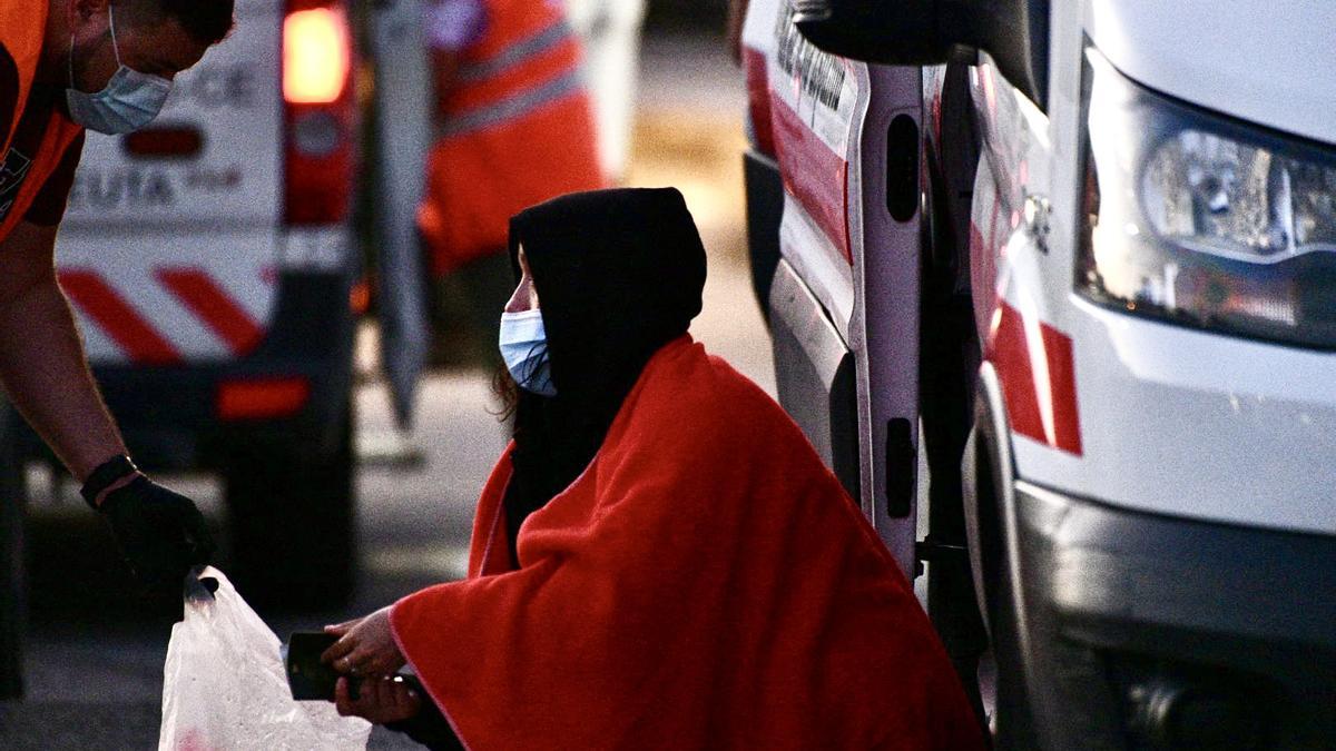 Una emigrante es atendida por un voluntario de la Cruz Roja en Ceuta