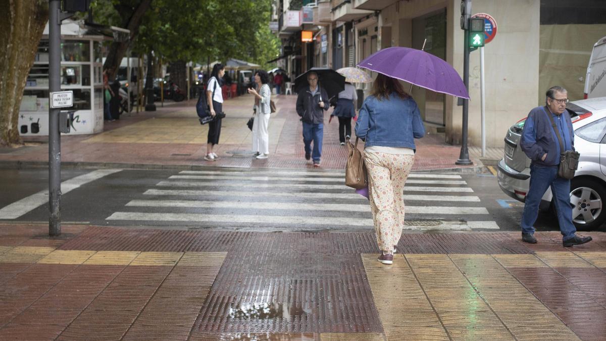 Gente paseando con paraguas por el centro de Xàtiva, en una imagen de archivo.