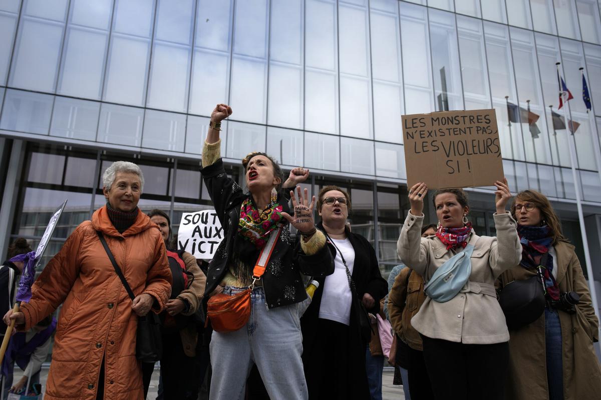 Women's rights activists demonstrate outside the Paris palace of justice as French actor Gérard Depardieu, who is facing trial for the alleged sexual assaults of two women on a film set in 2021, won't appear before a criminal court, Monday, Oct. 28, 2024 in Paris. (AP Photo/Louise Delmotte)
