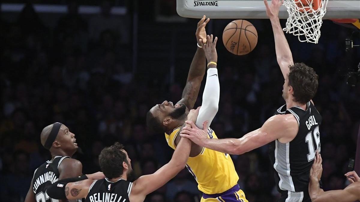 Pau Gasol intenta taponar un tiro de Lebron James, mientras es objeto de falta