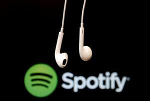 FILE PHOTO: Headphones are seen in front of a logo of online music streaming service Spotify,  February 18, 2014 REUTERS/Christian Hartmann//File Photo