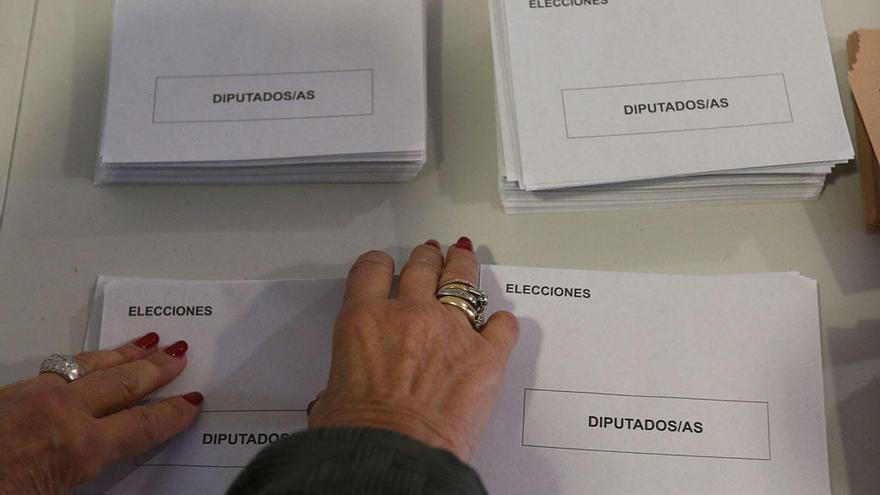 Una mujer coge sobres para votar en las elecciones de 2015.