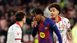 Barcelonas Lamine Yamal argues with Gironas Joel Roca during a Spanish La Liga soccer match between Girona and Barcelona in Girona, Spain, Monday, Feb. 16, 2026. (AP Photo/Joan Monfort)