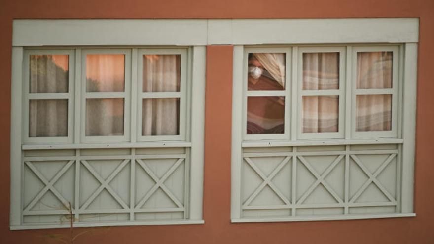 Un huesped del hotel en el sur de Tenerife en la ventana durante el aislamiento.