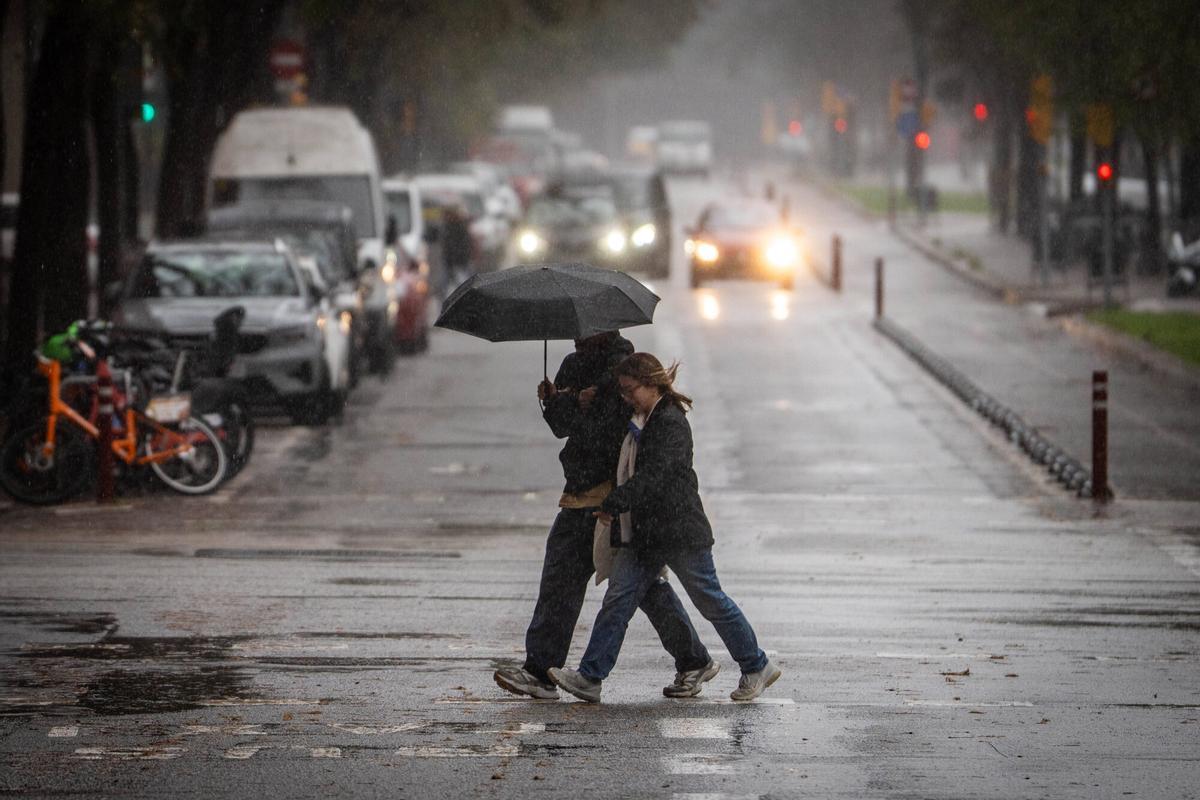 Personas con paraguas bajo la lluvia en Barcelona.