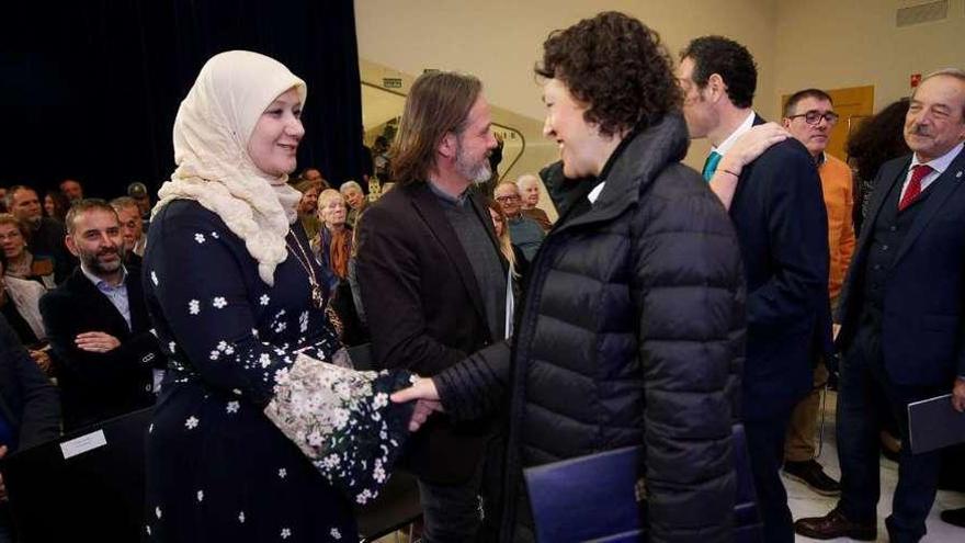 Magdalena Valerio saluda a Fátima Aljawish; junto a ella, el responsable de Accem en Asturias, Javier Mahía, y, a la derecha, el consejero Guillermo Martínez y el alcalde de Oviedo, Wenceslao López.