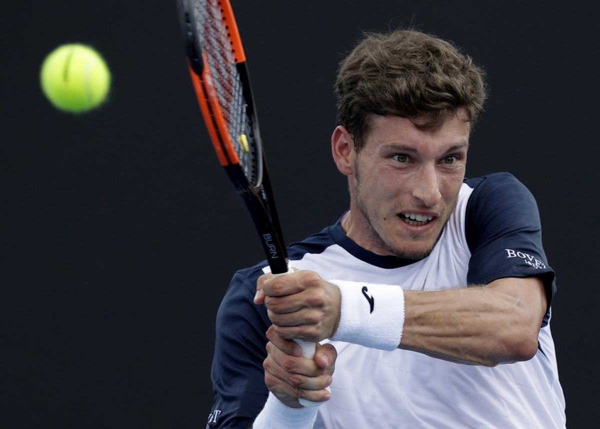 Spain’s Pablo Carreno Busta makes a backhand return to Ilya Ivashka of Belarus during their second round match at the Australian Open tennis championships in Melbourne, Australia, Thursday, Jan. 17, 2019. (AP Photo/Kin Cheung)