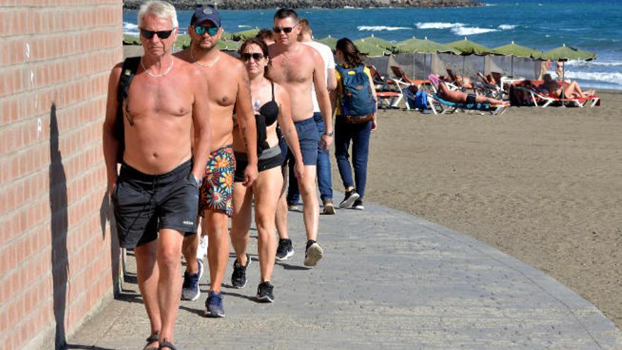 En la imagen, captada ayer, un grupo de turistas pasea en el sur de Gran Canaria.