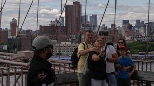 Un grup de turistes es fa un ‘selfie’ al pont de Brooklyn de Nova York, ahir.  | ADAM GRAY / AFP