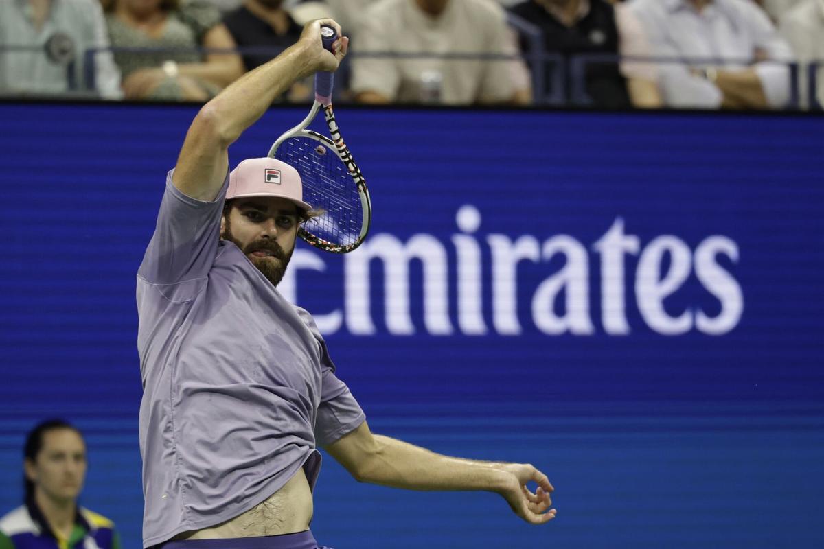 Reilly Opelka, of the United States, returns a shot to Carlos Alcaraz, of Spain, during the first round of the U.S. Open tennis championships, Monday, Aug. 25, 2025, in New York. (AP Photo/Adam Hunger)