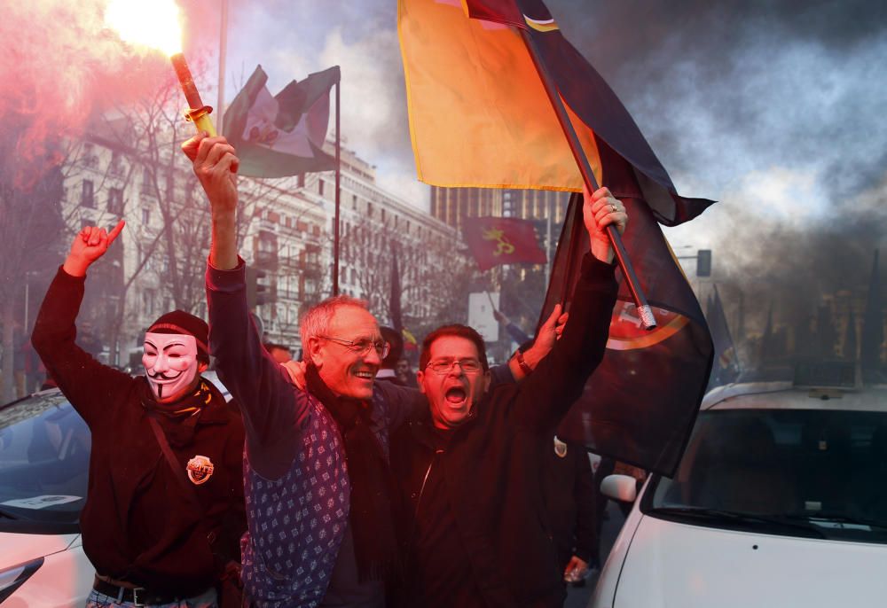 Spanish taxi drivers shout slogans holding a ...