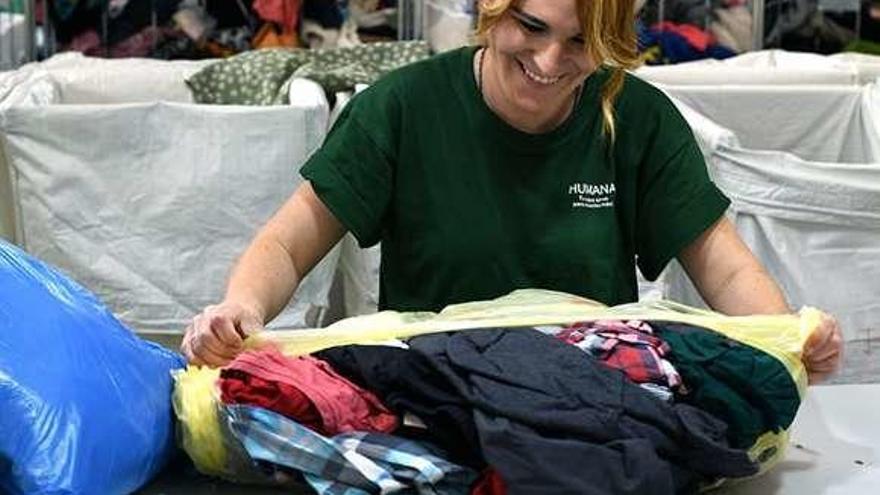 Trabajadora de la Fundación Humana separando la ropa. // FdV