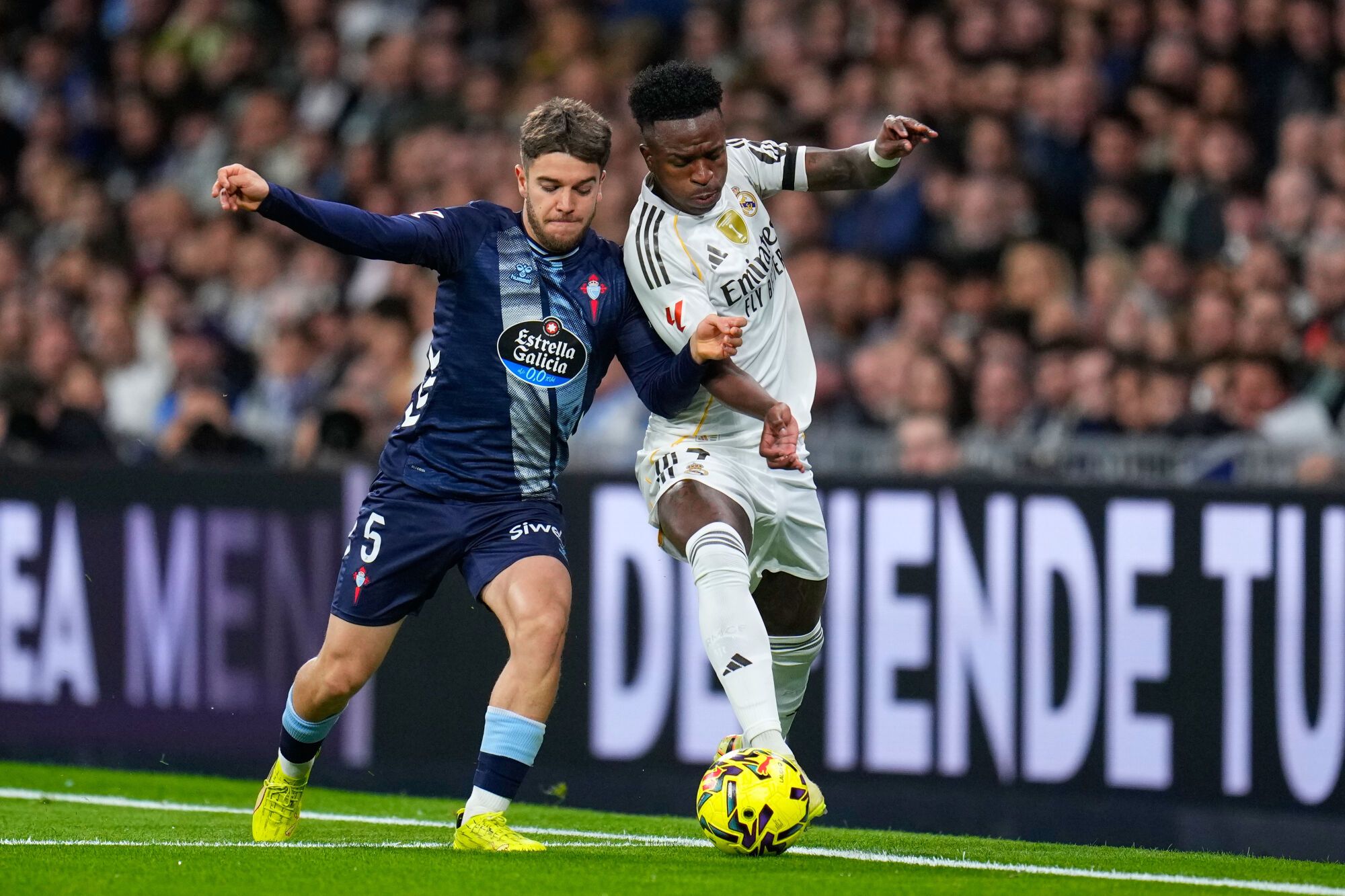 Real Madrid's Kylian Mbappe is challenged by Celta's Sergio Carreira during the Spanish La Liga soccer match between Real Madrid and Celta Vigo in Madrid, Spain, Sunday, Dec. 7, 2025. (AP Photo/Manu Fernandez)