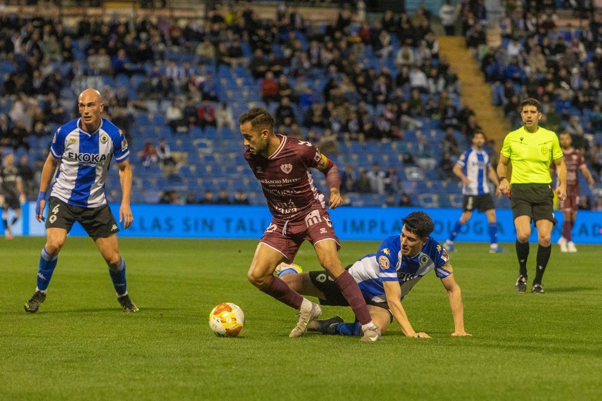 Roger Colomina cae al suelo con el colegiado David López Giménez al fondo siguiendo la acción.