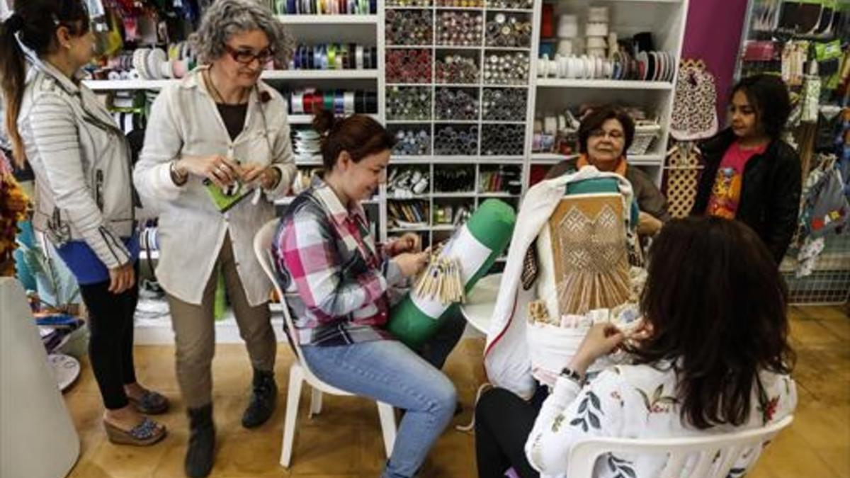 Gemma Vidal (segunda por la izquierda) departe con clientas en la mercería Fòrum de Labors, el martes.