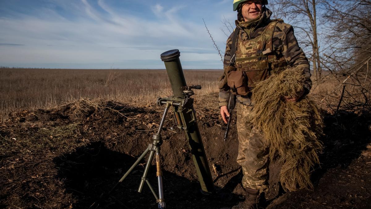 A Ukrainian serviceman prepares a mortar to shoot at a frontline in Donetsk Region