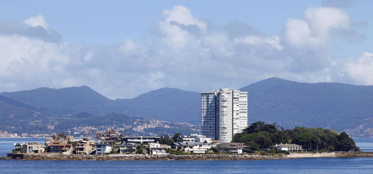 Vista de la isla de Toralla,con su torre de viviendasrodeada de casas y chalés.