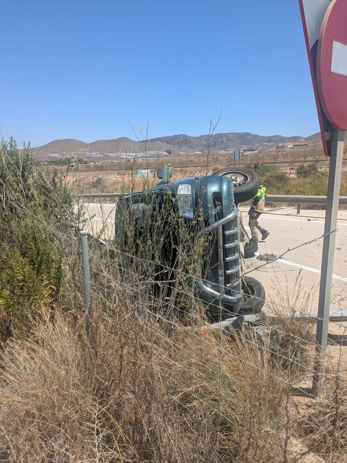 La furgoneta, volcada sobre el asfalto.