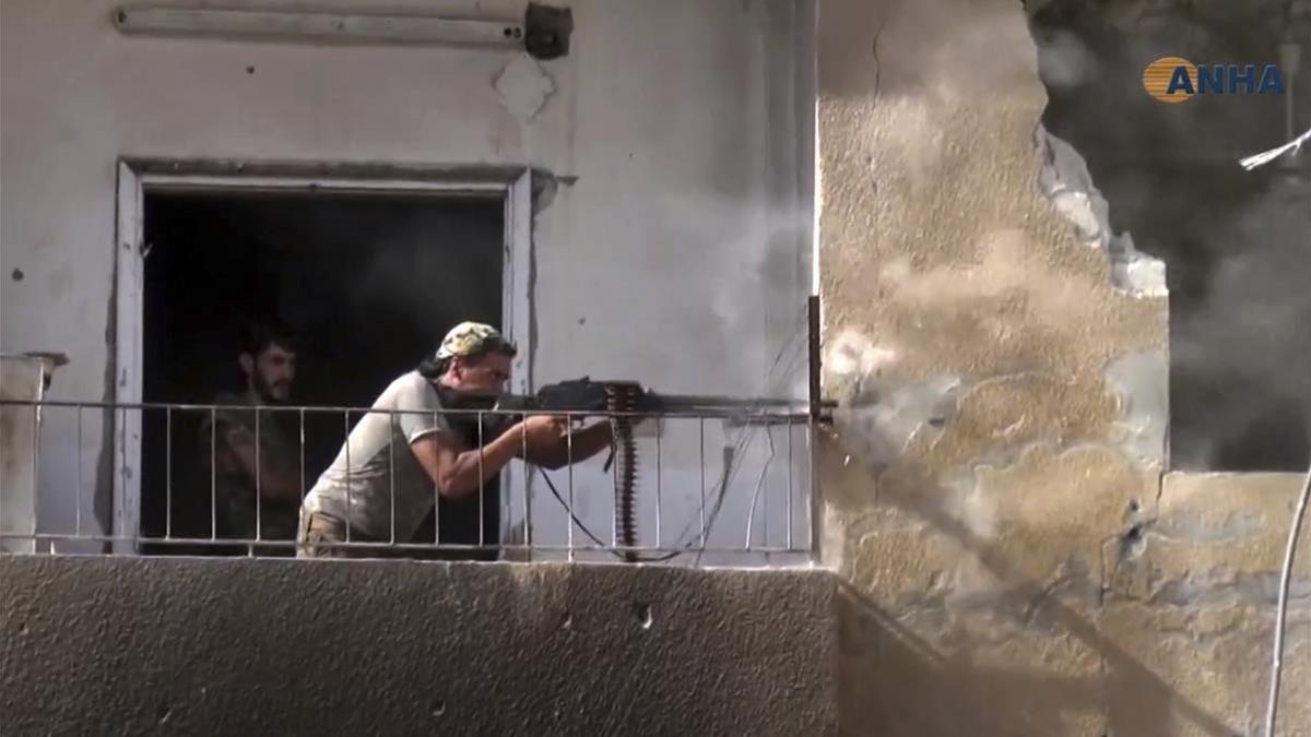 Un combatiente de las FDS dispara contra posiciones yihadistas en Raqqa, en una imagen de vídeo facilitada por la agencia kurdosiria Hawar, el 3 de agosto.