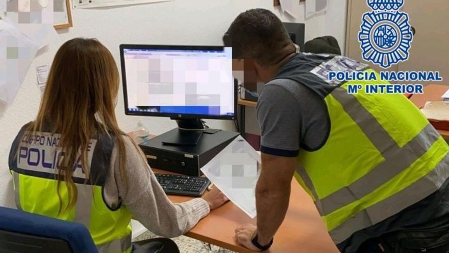 Dos policías nacionales durante la investigación de un ciberdelito en Canarias.