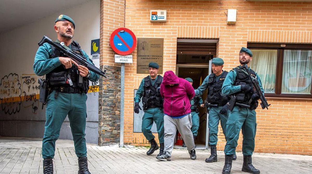 Agentes de la Guardia Civil llevan detenido al hombre imputado por la muerte de una mujer en un tiroteo en Las Ventas de Retamosa (Toledo).