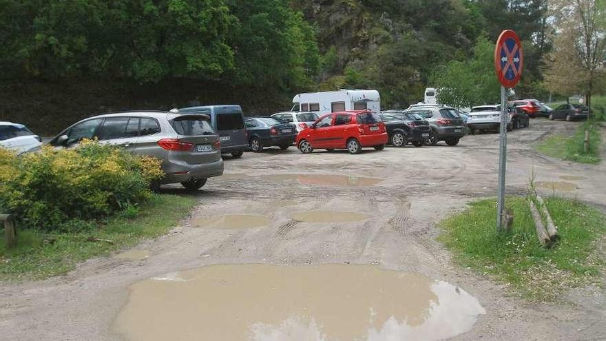 La zona de aparcamiento esta llena de socavones y dificulta su acceso a vehículos y personas. // Iñaki Osorio