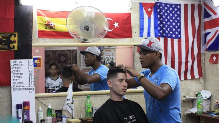 Una peluquería con la bandera cubana junto a la estadounidense.