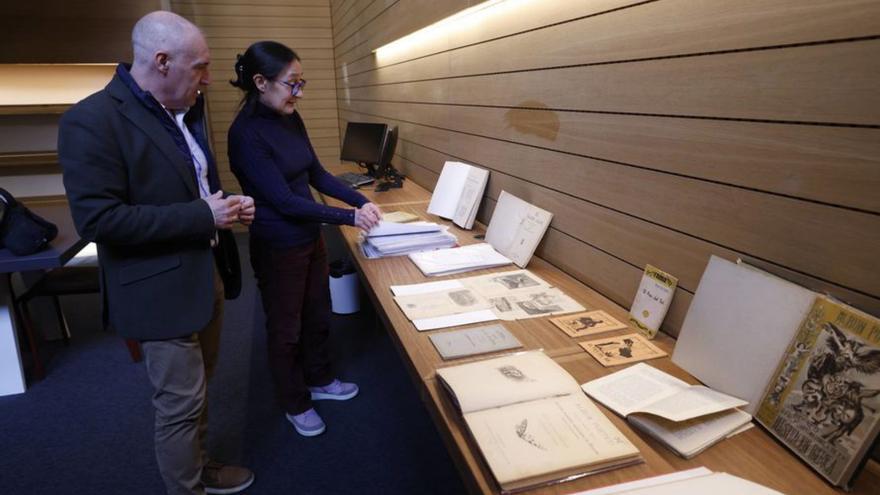 El concejal de Atención a la Ciudadanía y Distritos, Abel Junquera, y la bibliotecaria, Carmen Menéndez junto a parte de la colección documental sobre Rosario Acuña en la antigua Escuela de Comercio.