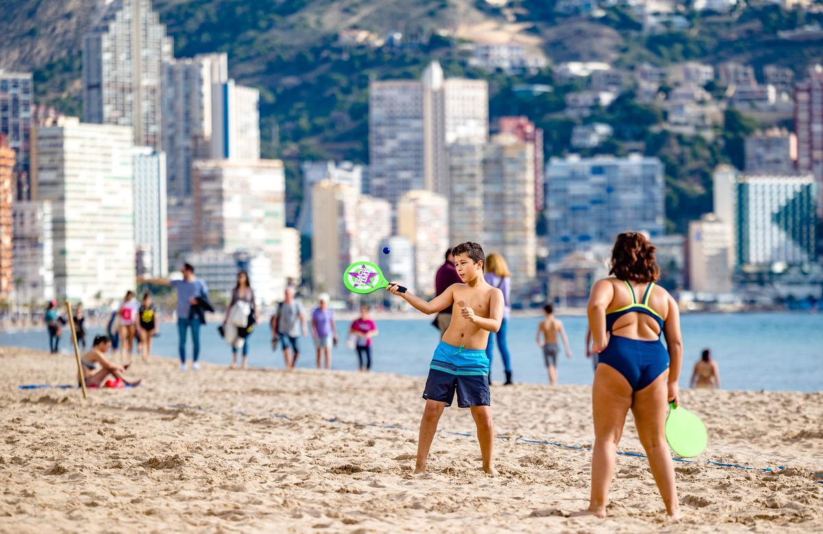 Unas personas jugando a las palas en una playa de Benidorm.