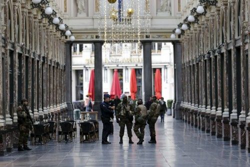Belgian soldiers patrol a shopping arcade where tourists frequented in central Brussels, after security was tightened in Belgium following the fatal attacks in Paris