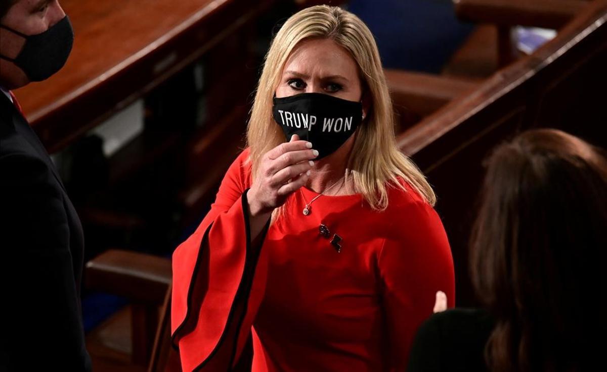 FILE PHOTO  U S  Rep  Marjorie Taylor Greene (R-GA) wears a  Trump Won  face mask as she arrives on the floor of the House to take her oath of office as a newly elected member of the 117th House of Representatives in Washington  U S   January 3  2021    REUTERS Erin Scott Pool File Photo
