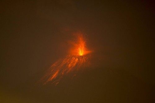 The Tungurahua volcano spews lava as pictured from the city of Huambalo, Ecuador
