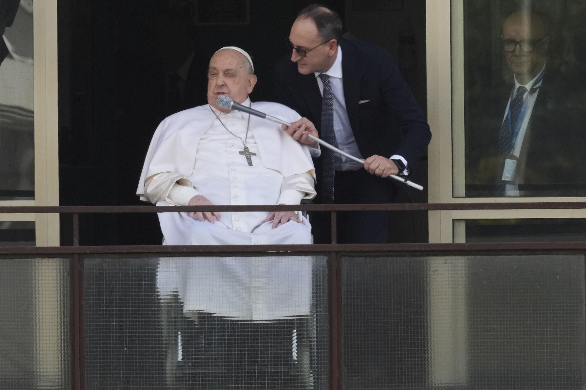 Pope Francis appears at a window of the Agostino Gemelli Polyclinic in Rome, Sunday, March 23, 2025, where he has been treated for bronchitis and bilateral pneumonia since Feb. 14. (AP Photo/Andrew Medichini). EDITORIAL USE ONLY/ONLY ITALY AND SPAIN
