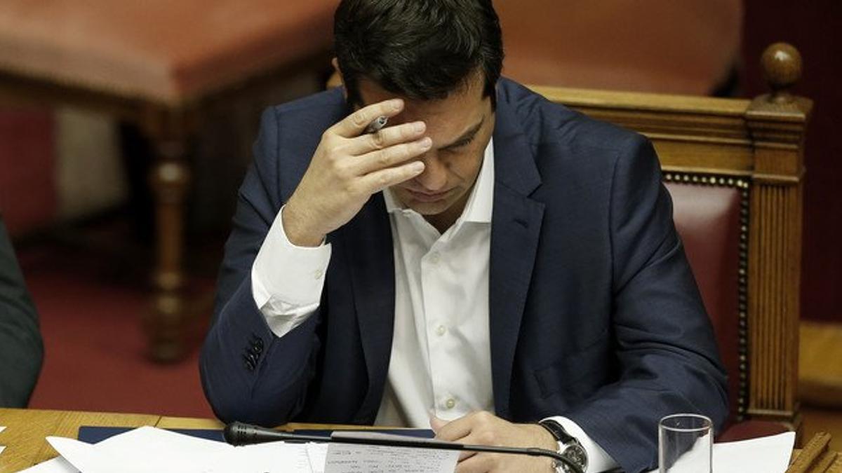 El primer ministro griego Alexis Tsipras repasa unas notas en el Parlamento.