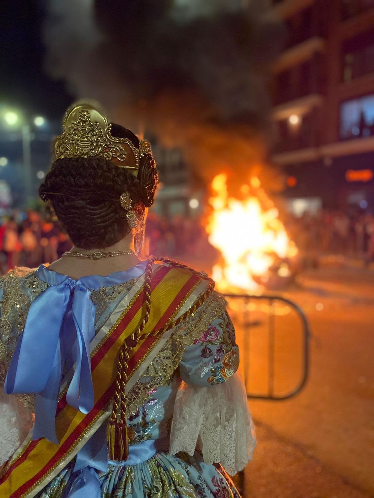 Una fallera presencia la 'cremà' de una falla, uno de los momentos más emotivos de las fiestas josefinas.