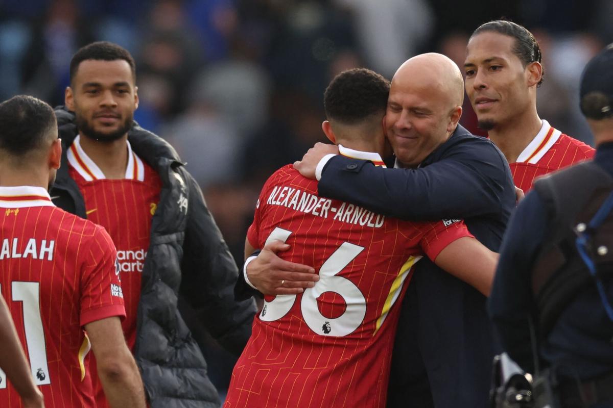 TOPSHOT - Liverpool's Dutch manager Arne Slot embraces goal-scorer Liverpool's English defender #66 Trent Alexander-Arnold on the pitch after the English Premier League football match between Leicester City and Liverpool at King Power Stadium in Leicester, central England on April 20, 2025. Leicester were relegated from the Premier League after a 1-0 defeat to Liverpool. (Photo by Darren Staples / AFP) / RESTRICTED TO EDITORIAL USE. No use with unauthorized audio, video, data, fixture lists, club/league logos or 'live' services. Online in-match use limited to 120 images. An additional 40 images may be used in extra time. No video emulation. Social media in-match use limited to 120 images. An additional 40 images may be used in extra time. No use in betting publications, games or single club/league/player publications. /. SEE CAPTION FOR MORE INFORMATION / RESTRICTED TO EDITORIAL USE. No use with unauthorized audio, video, data, fixture lists, club/league logos or 'live' services. Online in-match use limited to 120 images. An additional 40 images may be used in extra time