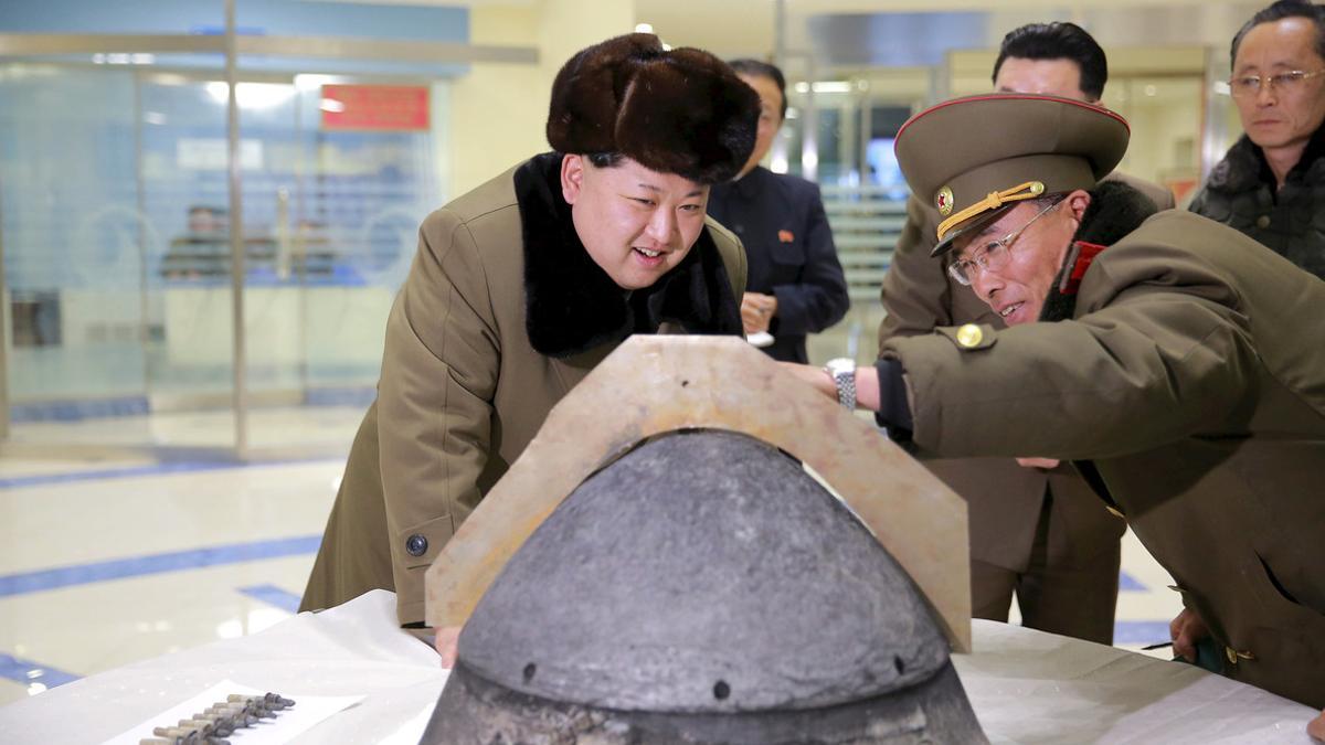 KCNA file picture shows North Korean leader Kim Jong Un looking at a rocket warhead tip after a simulated test of atmospheric re-entry of a ballistic missile