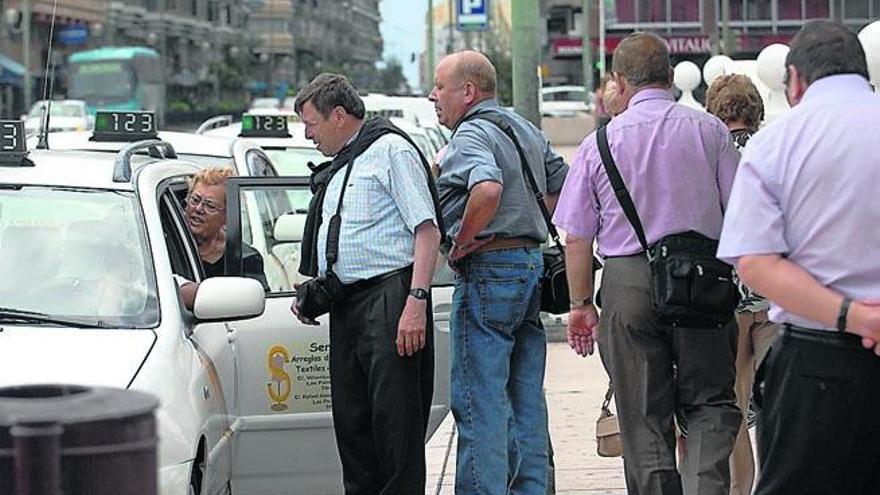 Un grupo de personas coge un taxi en la capital grancanaria.