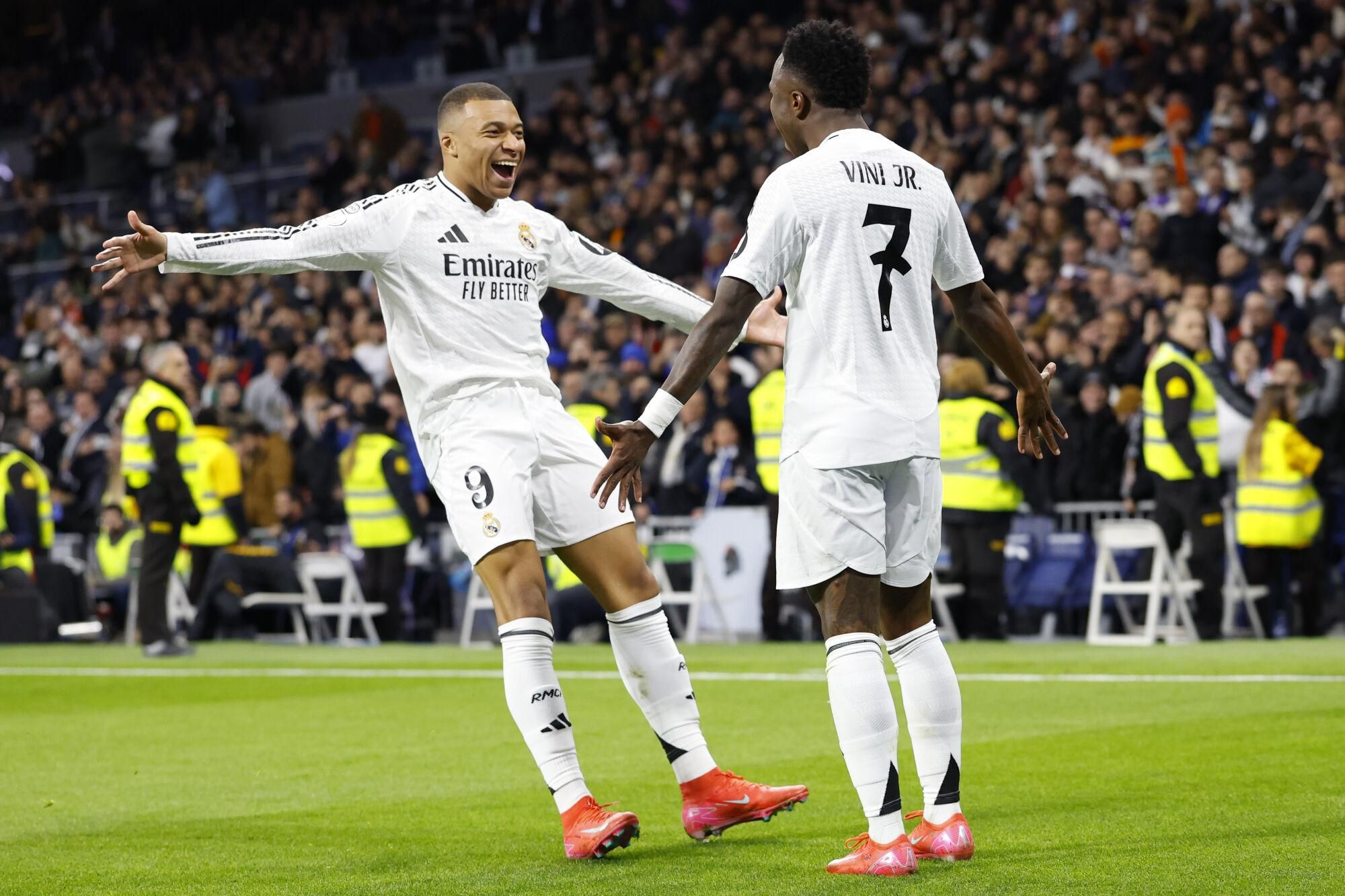 Real Madrid's Vinicius Junior, right, celebrates with Kylian Mbappe after scoring his side's 2nd goal against Celta de Vigo during a Copa del Rey round of 16 soccer match at the Santiago Bernabeu stadium in Madrid, Spain, Thursday, Jan. 16, 2025. (AP Photo/Pablo Garcia)