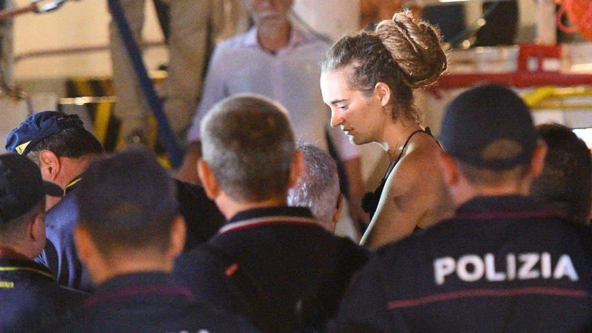 Carola Rackete, the 31-year-old Sea-Watch 3 captain, is escorted off the ship by police and taken away for questioning, in Lampedusa, Italy June 29, 2019. REUTERS/Guglielmo Mangiapane
