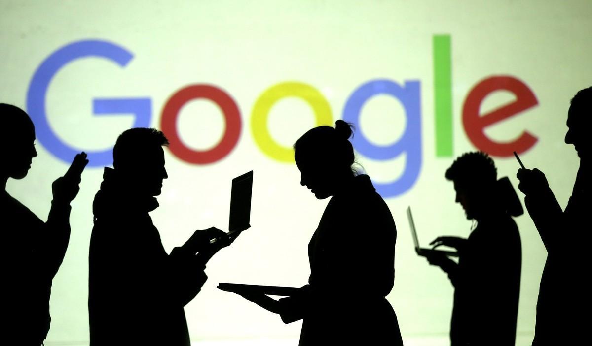 FILE PHOTO  Silhouettes of laptop and mobile device users are seen next to a screen projection of Google logo in this picture illustration taken March 28  2018   REUTERS Dado Ruvic Illustration File Photo