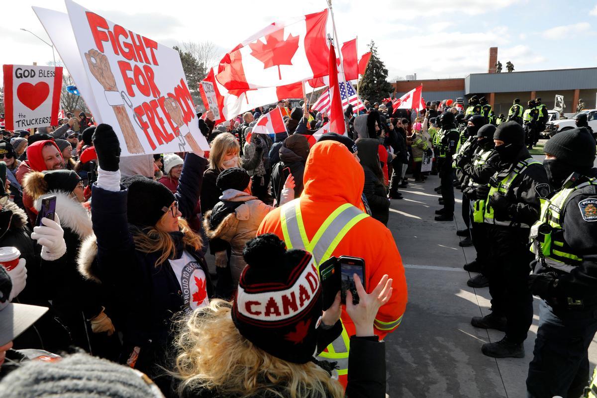 Manifestantes se enfrentan a la Policía Provincial de Ontario, en el momento en el que los agentes tratan de despejar la entrada del puente Ambassador, en Windsor (Ontario).